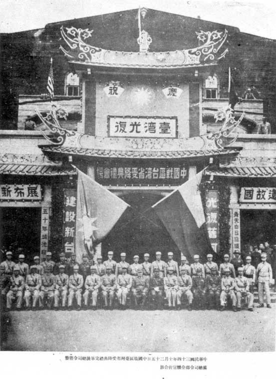 ​1945年10月25日，臺北公會堂舉行「中國戰區臺灣省受降典禮」後，臺灣省警備總司令部全體官兵合影。左半邊掛中國國民黨黨旗，右半邊掛中華民國國旗。
