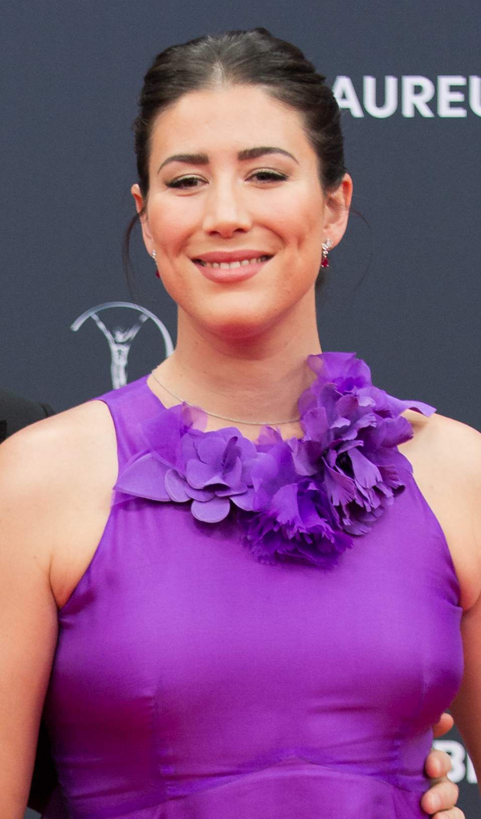 Garbiñe Muguruza, the celebrated Spanish tennis star, and her partner share a moment of unity on the red carpet at the 25th Laureus World Sports Awards in…