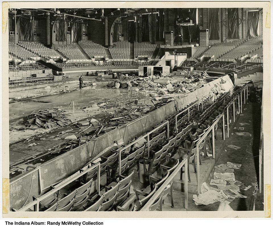 Aftermath of October 31, 1963 gas explosion at Indiana State Fairgrounds Coliseum, Indianapolis, Indiana, 1963. Stacks of chairs and debris near the…