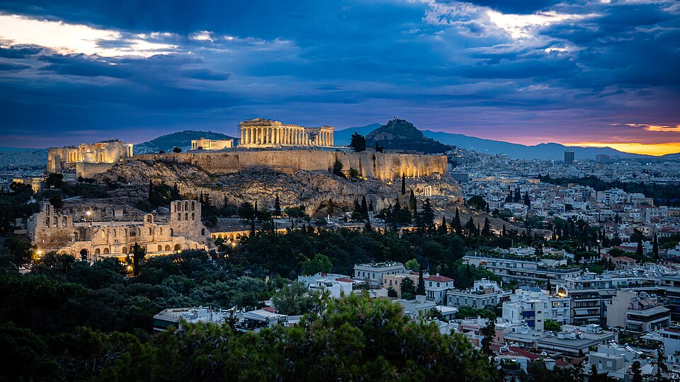 The first hints of sunrise brushed the Athens skyline, molten gold pressing against the lingering blues of night. From our perch on Philopappou Hill, the…