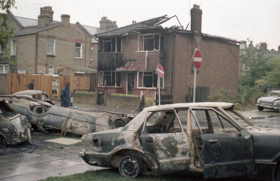 Overturned and burnt out cars in Broadwater Farm Estate on the day after the riots/uprising. Taken 7 October 1985.