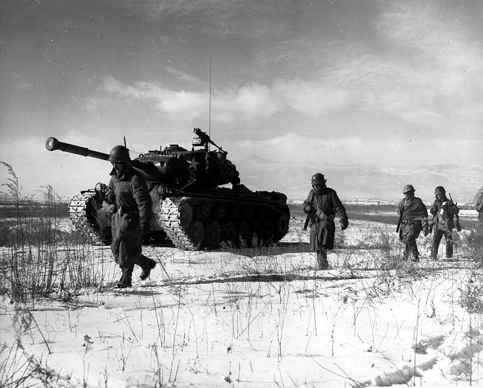 A column of troops and armor of the 1st Marine Division move through communist Chinese lines during their successful breakout from the Chosin Reservoir in…