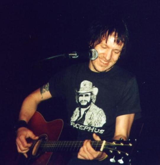 Elliott Smith performing at the Henry Fonda Theater in Los Angeles, CA on 2-1-2003. Picture taken by user llaurens of the Sweetadeline.net message board…