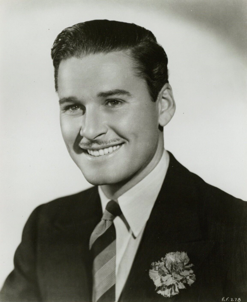 This is a publicity photo, circulated for publicity, of Errol Flynn , published in 1936 without copyright notice, qualifying it under public domain.