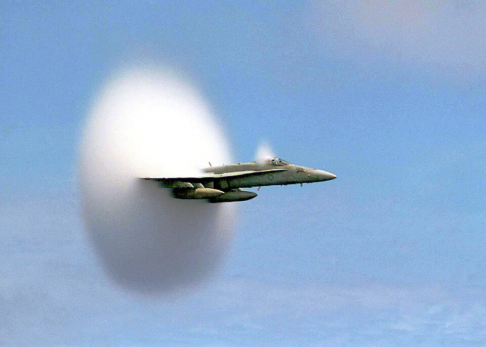 Off the coast of Pusan, South Korea: An F/A-18C Hornet assigned to Strike Fighter Squadron One Five One (VFA-151) breaks the sound barrier in the skies over…