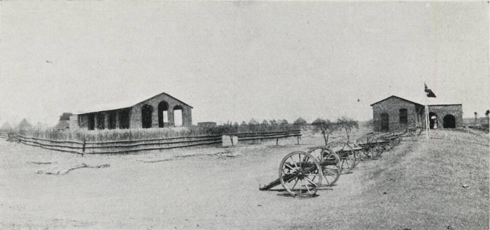 The governor's house in Fashoda - Kodok, 1906 (South) Sudan, with a line of cannons in front of the main building.