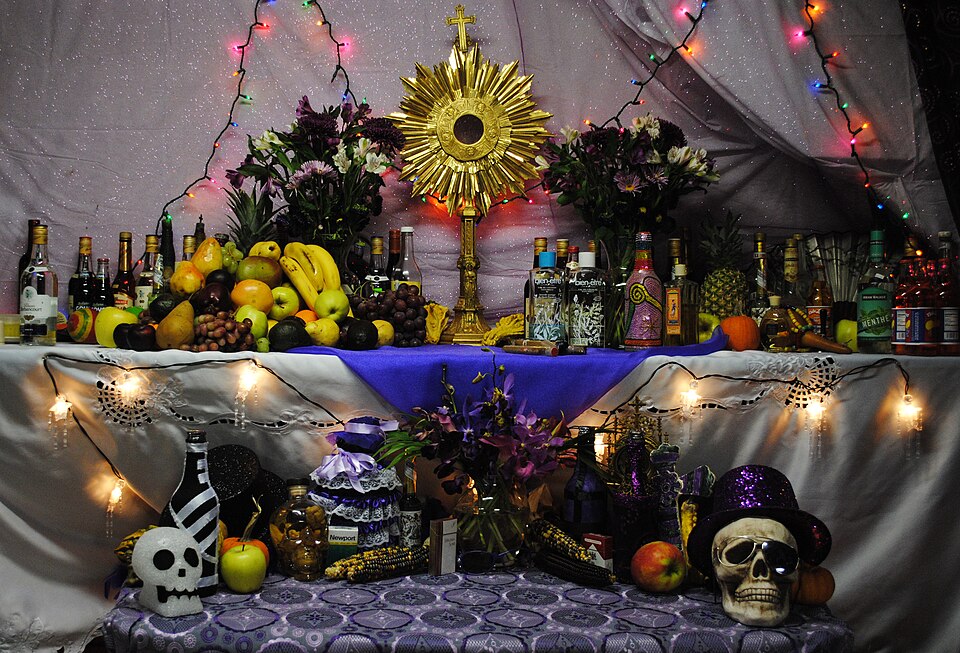 Haitian Vodou altar created during a festival for the Guede spirits, Boston, MA. Top right area is offerings to Rada spirits; top left to Petwo spirits;…