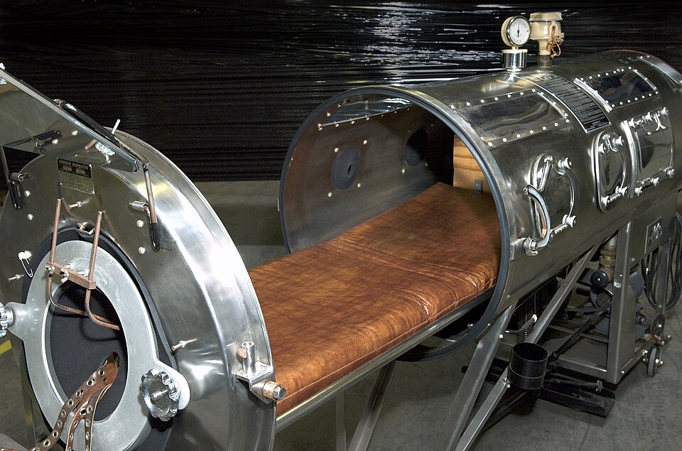 This photograph shows an opened artificial respirator commonly known as the iron lung. Polio patients of the 1950s depended on these devices to breathe…