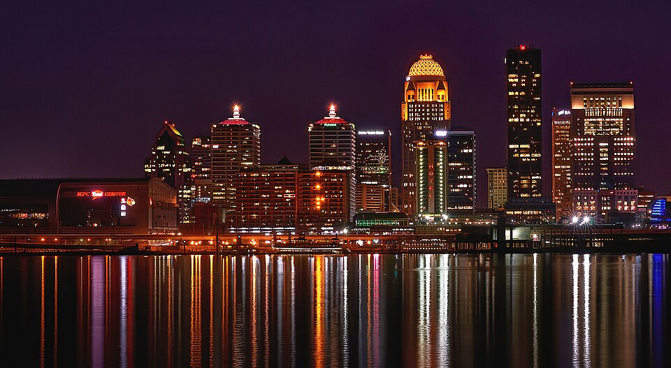 The skyline of Louisville, Kentucky, lit up at night, featuring the KFC Yum! Center and 400 West Market, among other buildings. Taken in 2021. Modified…