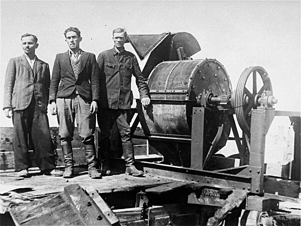 Former members of the Sonderkommando 1005 unit pose next to a bone crushing machine in the Janowska concentration camp in a photo taken by the Soviet war…