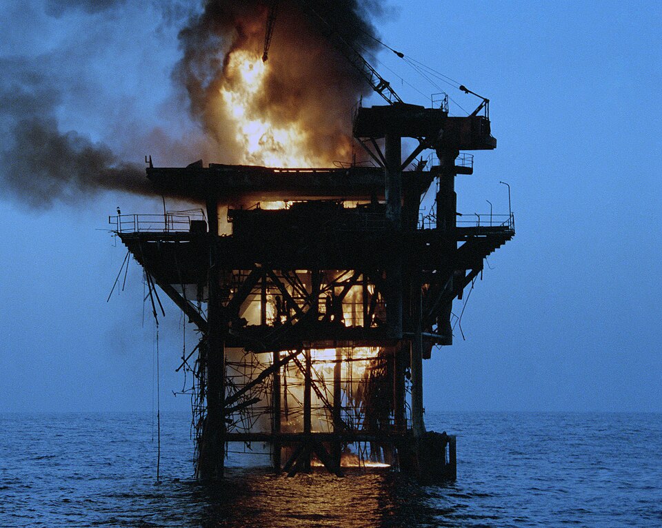 An Iranian oil platform, Rostam, is set afire after being shelled by four US Navy destroyers during Operation Nimble Archer. The shelling was a response to…