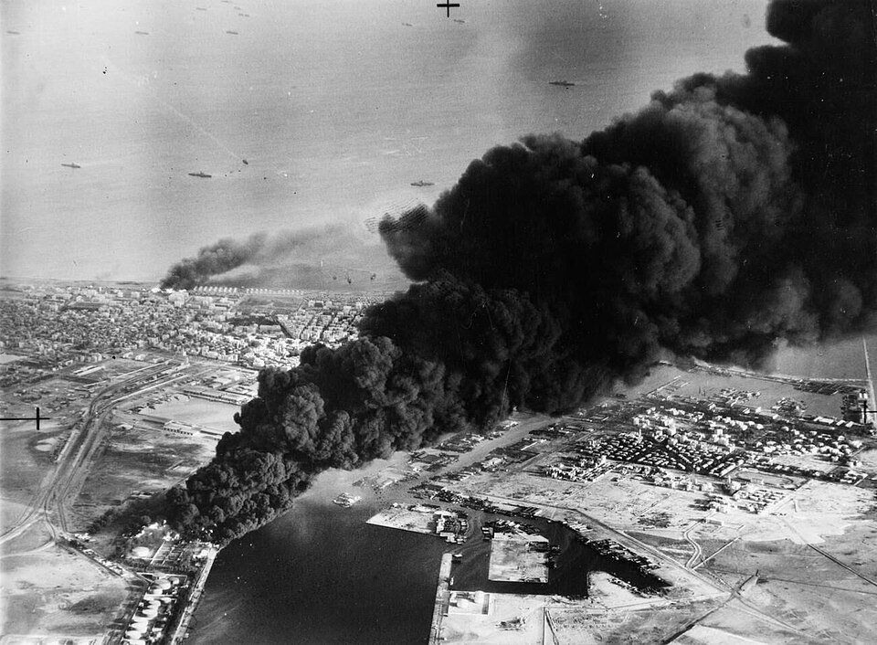 Smoke rises from oil tanks beside the Suez Canal hit during the initial Anglo-French assault on Port Said, 5 November 1956.