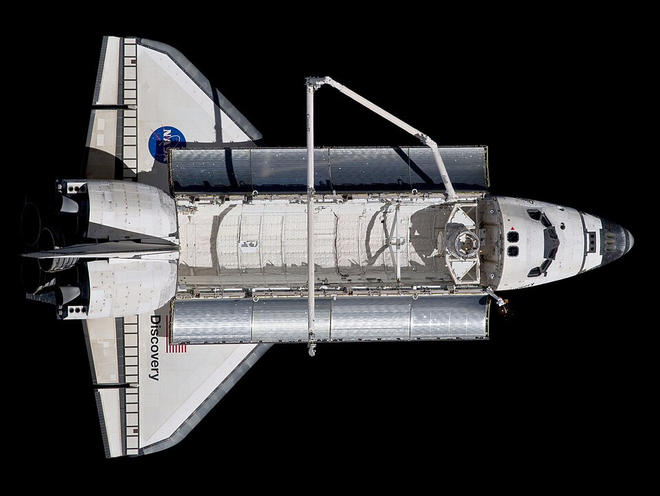 Backdropped against the blackness of space, Discovery is seen from the International Space Station as the two orbital spacecraft accomplish their relative…