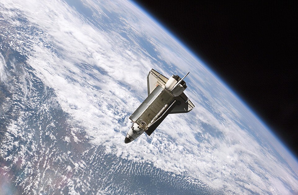 The Space Shuttle Atlantis , backdropped against clouds over Earth, is pictured after it undocked from the International Space Station at 7:50 a.m. CDT,…