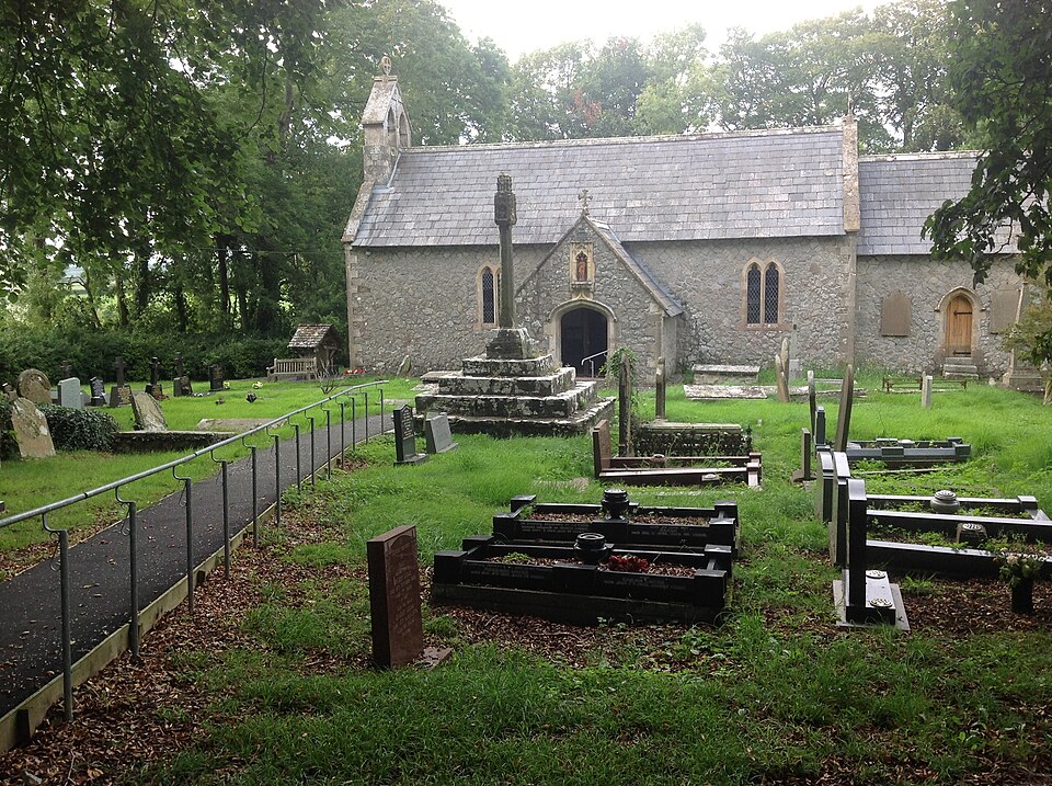 St Canna's Church in Llangan, Vale of Glamorgan, Wales. Central in the churchyard stands the medieval cross, while to the left of the church is a small open…