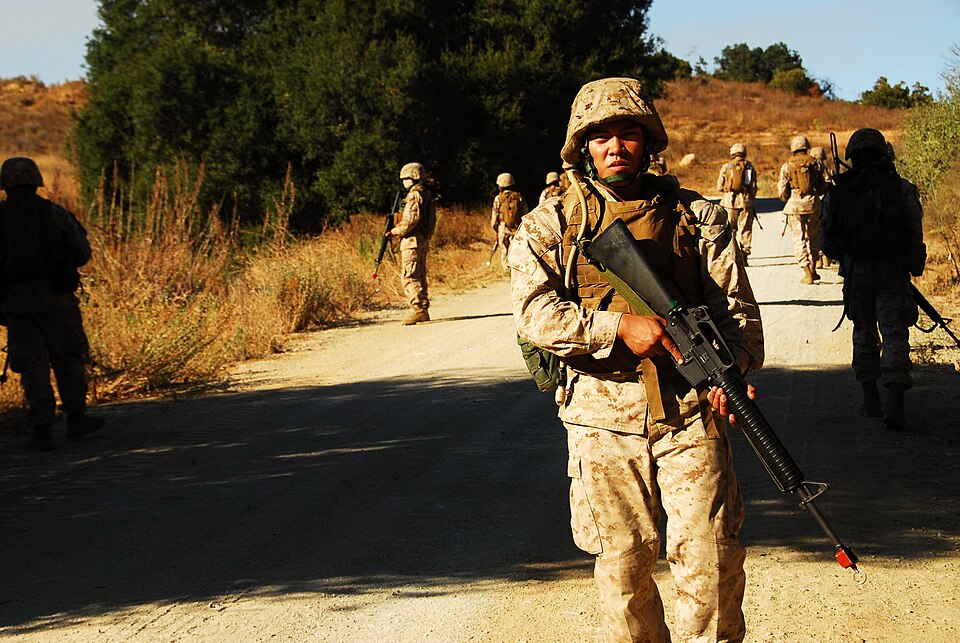 Lance Cpl. Christian Antonio, Intermediate Maintenance Activity asset manager, provides rear security during a simulated patrol at the Enhanced Combat…